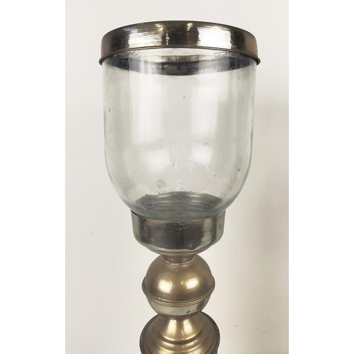 196 - STORM CANDLESTICKS, a pair, with glass shades, with a hammered metal column base, each 62cm H x 17cm... 