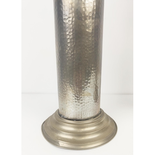 196 - STORM CANDLESTICKS, a pair, with glass shades, with a hammered metal column base, each 62cm H x 17cm... 