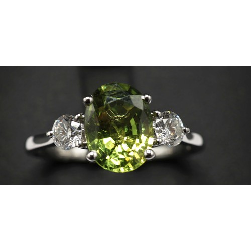 15 - 18CT WHITE GOLD TRILOGY RING SET, with a central oval green sapphire flanked by RBC diamond, sapphir... 