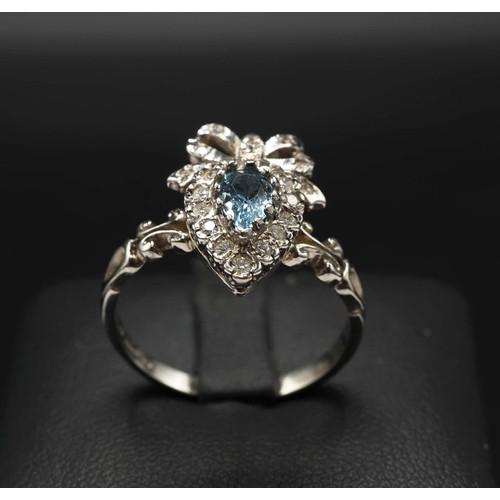 27 - 9CT WHITE GOLD BOW STYLE RING SET, with pear shaped blue topaz and RBC diamonds, topaz 0.30ct, diamo... 