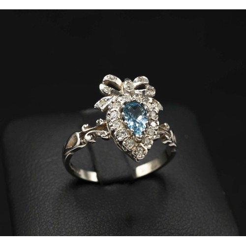 27 - 9CT WHITE GOLD BOW STYLE RING SET, with pear shaped blue topaz and RBC diamonds, topaz 0.30ct, diamo... 