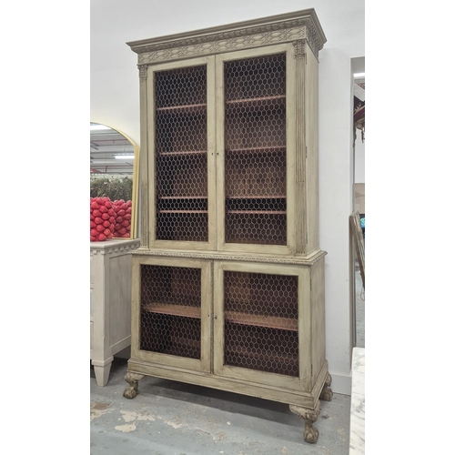 128 - BOOKCASE, 19th century grey painted with four chicken wire doors, the top with adjustable shelves on... 