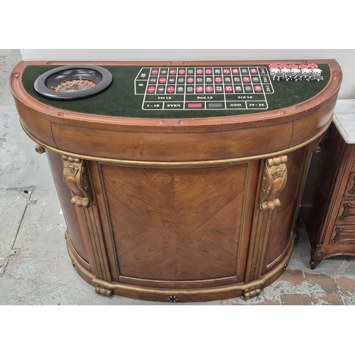 307 - CASINO BAR TABLE, demi lune with removable top revealing green baize games top with roulette wheel a... 