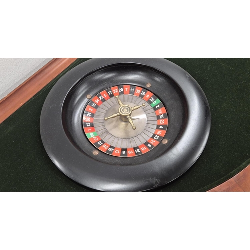 307 - CASINO BAR TABLE, demi lune with removable top revealing green baize games top with roulette wheel a... 