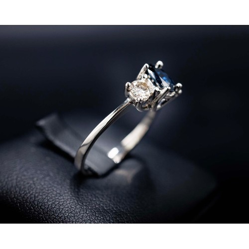 23 - 18CT WHITE GOLD OVAL-CUT SAPPHIRE AND RBC DIAMOND TRILOGY RING, sapphire 0.85ct approx, diamonds 0.4... 