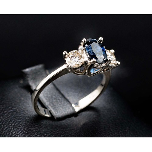 23 - 18CT WHITE GOLD OVAL-CUT SAPPHIRE AND RBC DIAMOND TRILOGY RING, sapphire 0.85ct approx, diamonds 0.4... 