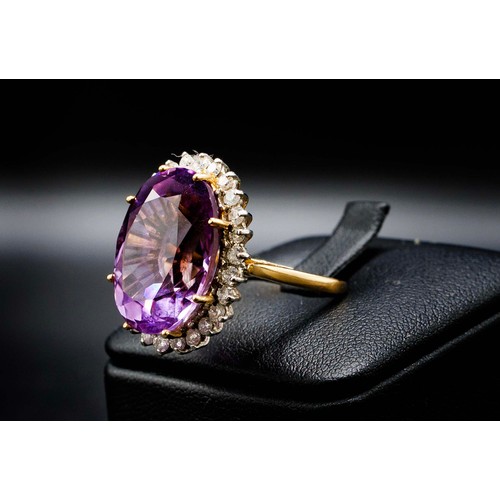 25 - 18CT YELLOW AND WHITE GOLD RING MULTI-CLAW SET, with a large oval amethyst surrounded by RBC diamond... 