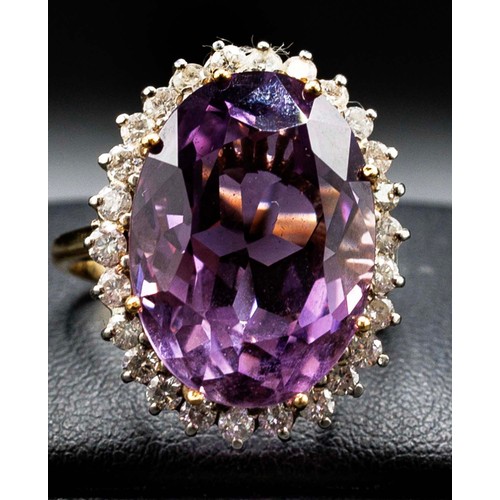 25 - 18CT YELLOW AND WHITE GOLD RING MULTI-CLAW SET, with a large oval amethyst surrounded by RBC diamond... 