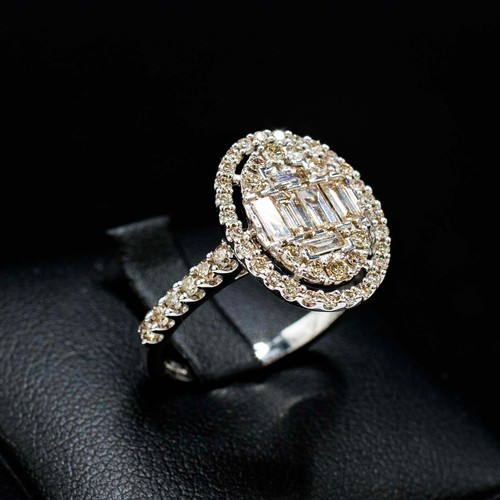 45 - LARGE OVAL CLUSTER RING SET, with baguette cut and round brilliant cut diamonds with diamond shoulde... 