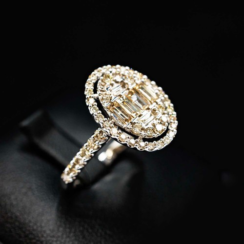 45 - LARGE OVAL CLUSTER RING SET, with baguette cut and round brilliant cut diamonds with diamond shoulde... 