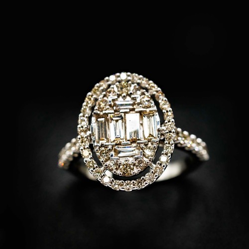 45 - LARGE OVAL CLUSTER RING SET, with baguette cut and round brilliant cut diamonds with diamond shoulde... 