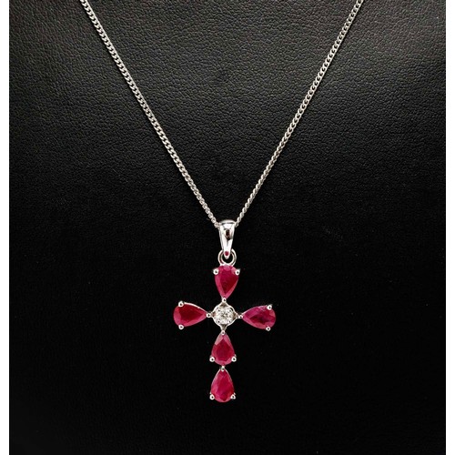 47 - 14CT WHITE GOLD CROSS PENDANT SET, with pear-shaped rubies and a single diamond, with silver chain, ... 