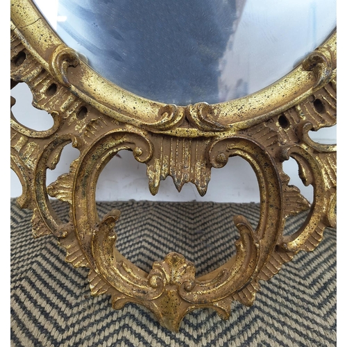 168 - WALL MIRROR, Chinese Chippendale style giltwood with oval plate and pagoda crest, 137cm H x 87cm.