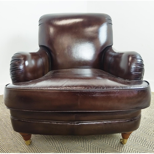 175 - HOWARD STYLE ARMCHAIR, dark brown leather with brass front castors, 89cm H x 80cm W x 105cm D.