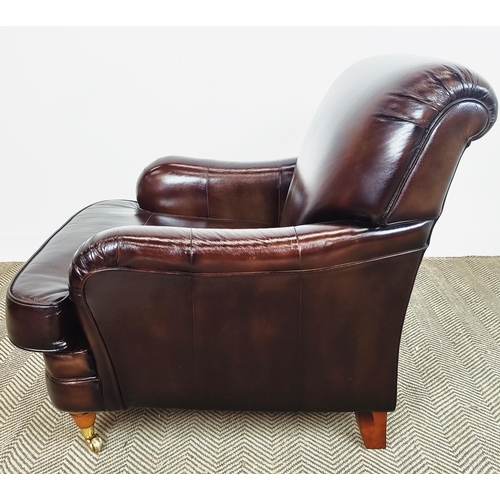 175 - HOWARD STYLE ARMCHAIR, dark brown leather with brass front castors, 89cm H x 80cm W x 105cm D.