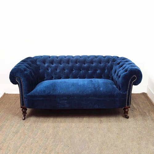 181 - CHESTERFIELD SOFA, Victorian walnut in blue velvet on ceramic castors, 67cm H x 202cm x 85cm.