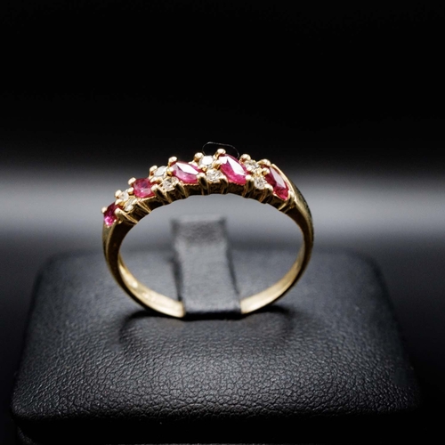 57 - 9CT YELLOW GOLD 9-STONE MARQUISE RUBY AND R/C DIAMOND RING, boxed.