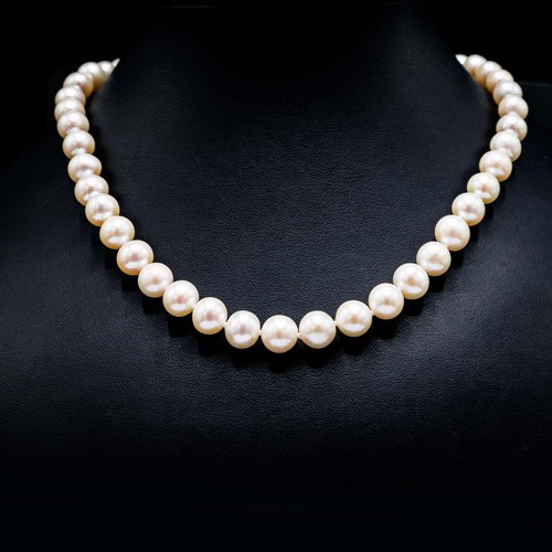 46 - ROUND WHITE CULTURED PEARL-STRUNG NECKLACE, with 9ct yellow gold ball clasp.