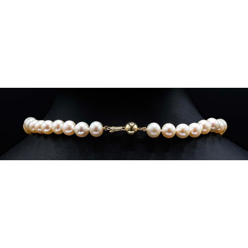 46 - ROUND WHITE CULTURED PEARL-STRUNG NECKLACE, with 9ct yellow gold ball clasp.