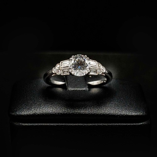 49 - CERTIFICATED 18CT WHITE GOLD DIAMOND SOLITAIRE RING SET, with RBC and baguette cut diamond shoulders... 