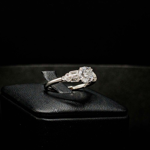 49 - CERTIFICATED 18CT WHITE GOLD DIAMOND SOLITAIRE RING SET, with RBC and baguette cut diamond shoulders... 