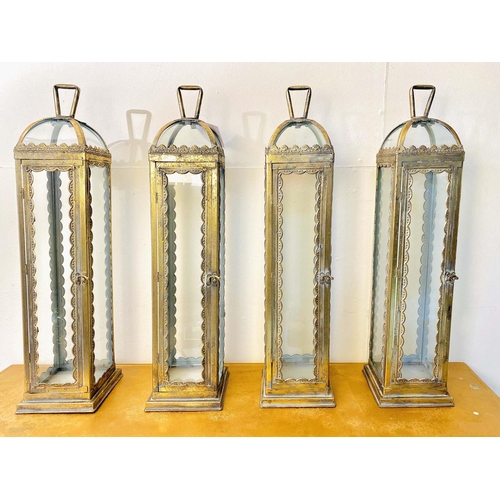 536 - LANTERNS, a set of four, Regency style gilt metal and glass, 62cm H x 15cm W x 15cm D. (4)