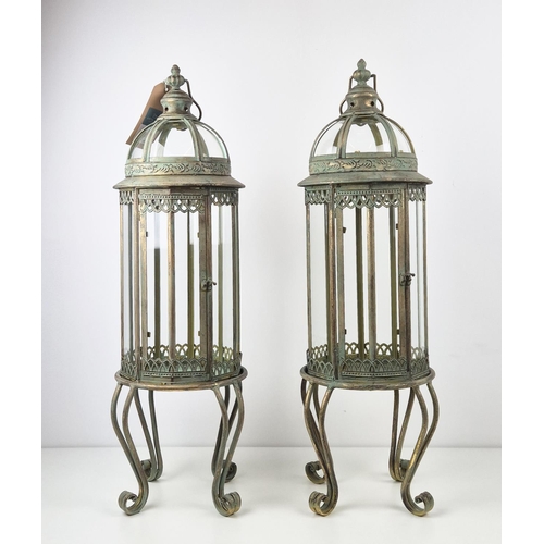 509 - LANTERNS ON STANDS, a pair, with a faux verdigris finish, 82cm H. (2)