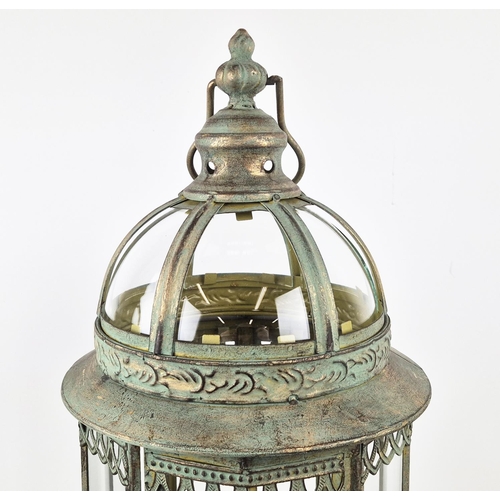 509 - LANTERNS ON STANDS, a pair, with a faux verdigris finish, 82cm H. (2)