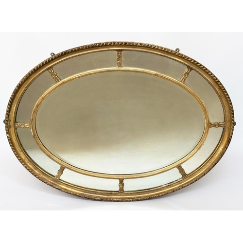 501 - WALL MIRROR, early 20th century George III design oval carved giltwood and gesso, moulded with bevel... 