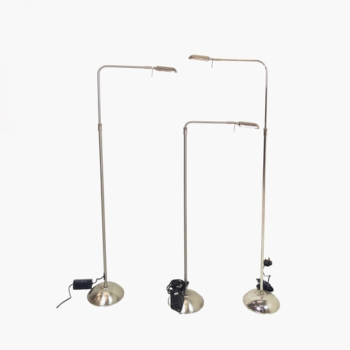 457 - FLOOR LAMPS, a set of three, height adjustable, polished metal, 133cm H at tallest approx. (3)