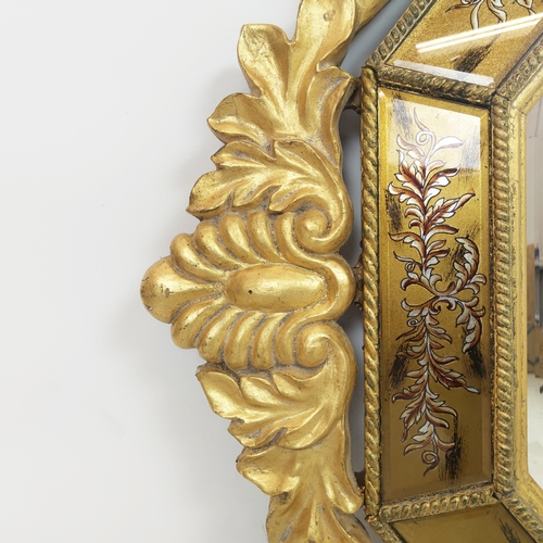 98 - WALL MIRRORS, a pair, gilt and eglomise framed with bevelled octagonal plates, 132cm H x 79cm. (2)