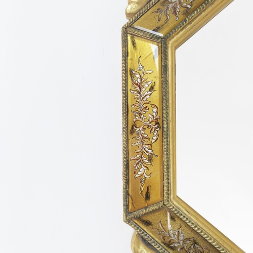 98 - WALL MIRRORS, a pair, gilt and eglomise framed with bevelled octagonal plates, 132cm H x 79cm. (2)