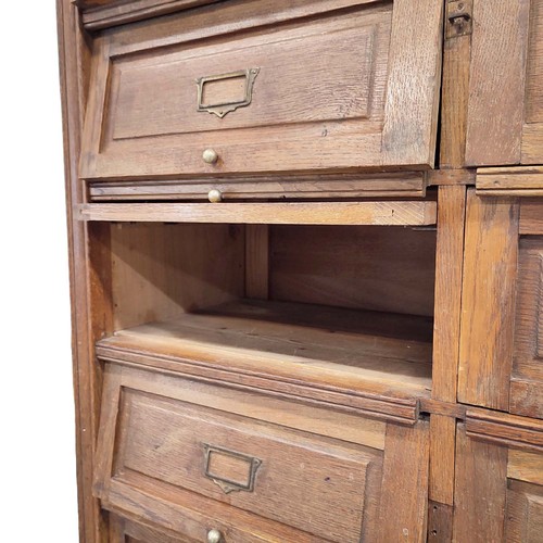 447 - HABERDASHERY CABINET, early 20th century French oak with twenty lift up doors, 213cm H x 95cm W x 38... 