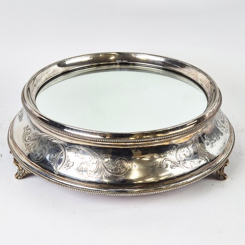 15 - A 20TH CENTURY CAKE STAND STAND, silver plated, mirrored surface, 40cm diam, with original early car... 