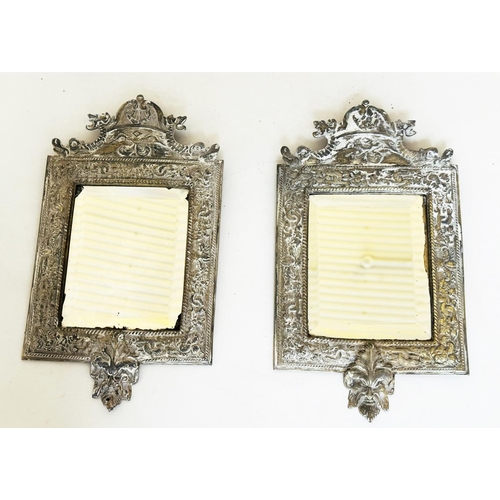 543 - WALL MIRRORS, a pair, early 20th century silvered metal with bevelled plates and lion mask frames, 3... 