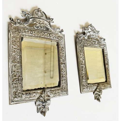 543 - WALL MIRRORS, a pair, early 20th century silvered metal with bevelled plates and lion mask frames, 3... 