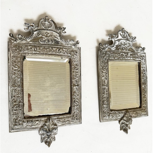 543 - WALL MIRRORS, a pair, early 20th century silvered metal with bevelled plates and lion mask frames, 3... 