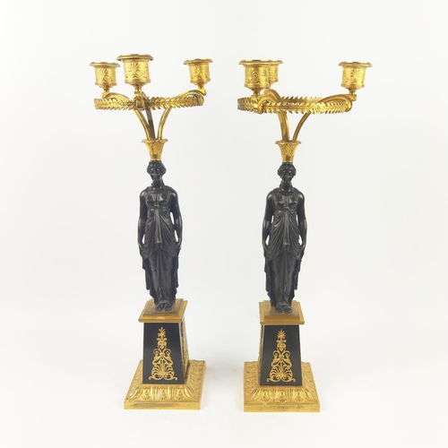 12 - A PAIR OF BRONZE AND GILT METAL CANDELABRA, figural columns, bronze and gilt metal stands, triple ca... 