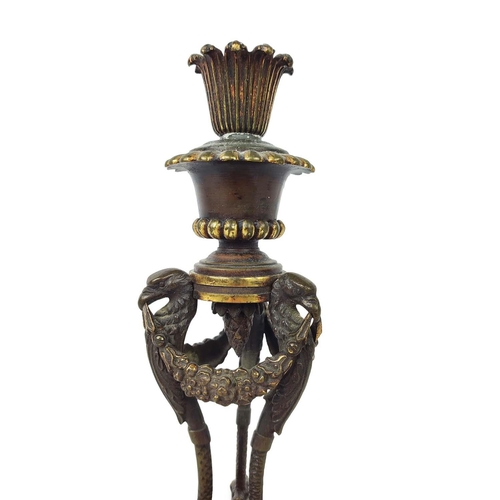 17 - CANDLESTICKS, a pair, 19th century French Empire, fashioned as braziers, triform eagle supports with... 