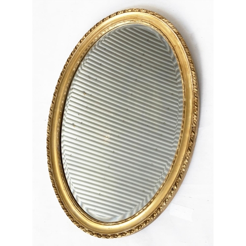 195 - WALL MIRROR, oval George III design giltwood and gesso moulded with bevelled mirror, 82cm x 60cm H.