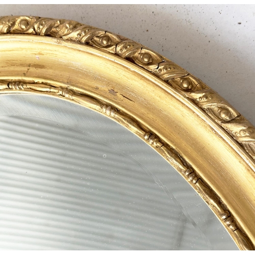 195 - WALL MIRROR, oval George III design giltwood and gesso moulded with bevelled mirror, 82cm x 60cm H.