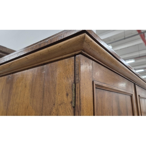 201 - REGENCY OAK AND HOLLY WARDROBE, with a pair of panelled doors enclosing hanging space over a drop fr... 