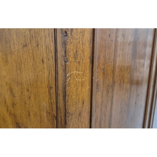 201 - REGENCY OAK AND HOLLY WARDROBE, with a pair of panelled doors enclosing hanging space over a drop fr... 