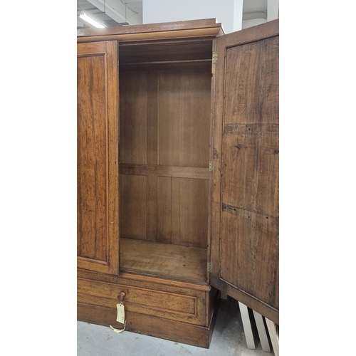 201 - REGENCY OAK AND HOLLY WARDROBE, with a pair of panelled doors enclosing hanging space over a drop fr... 