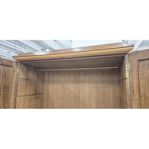 201 - REGENCY OAK AND HOLLY WARDROBE, with a pair of panelled doors enclosing hanging space over a drop fr... 