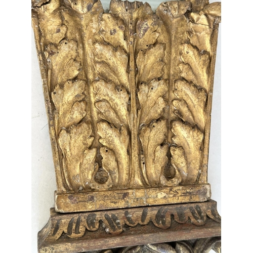 235 - WALL MIRROR, early 19th century Italian carved giltwood, trapezoid with crest, 88cm H x 33cm W.