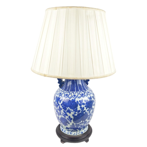 29 - CHINESE LAMPS, a pair, with blue and white peony decoration and pleated silk shades and another pair... 