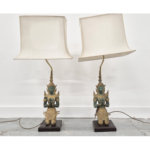 292 - THAI FIGURAL TABLE LAMPS, a pair, verdigris and gilt metal, with shades, 94cm H. (2)