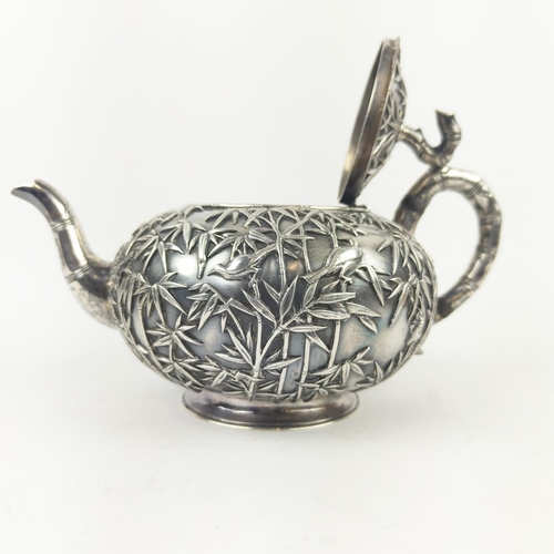 31 - CHINESE EXPORT SILVER THREE PIECE TEASET, by Wang Hing, comprising teapot, sugar bowl and milk jug, ... 