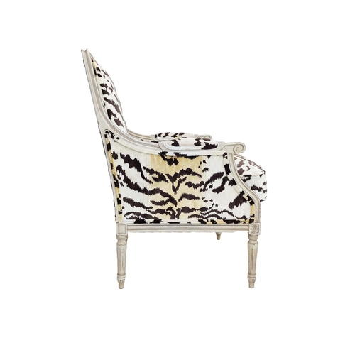 462 - ANDREW MARTIN BERGERE ARMCHAIRS, a pair, in animal print velvet, each 66cm x 100cm H x 70cm. (2)